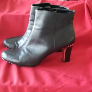 Black dressy ankle boots with gold inlay.